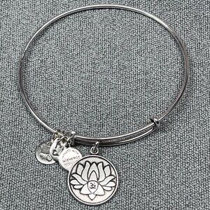 Alex and Ani silver tone bangle bracelet with lotus flower charm.